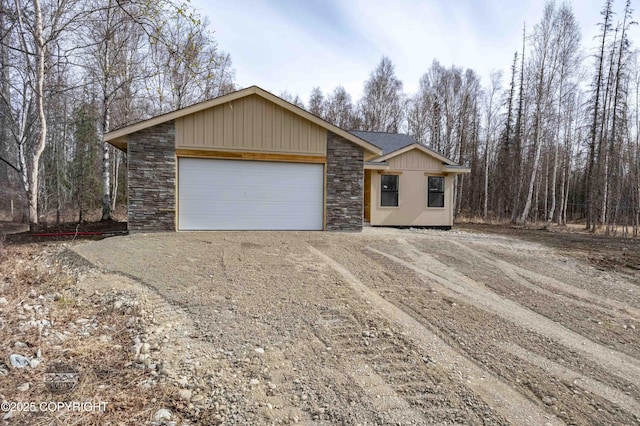 7177 N Paw St, Wasilla, AK 99654 - ranch-style house with an attached garage, driveway, and stone siding