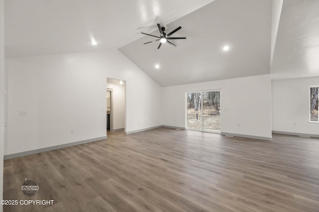 7177 N Paw St, Wasilla, AK 99654 - unfurnished living room with ceiling fan, wood finished floors, high vaulted ceiling, baseboards, and recessed lighting