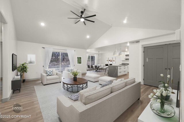 7177 N Paw St, Wasilla, AK 99654 - living room with ceiling fan, high vaulted ceiling, baseboards, light wood-style floors, and recessed lighting