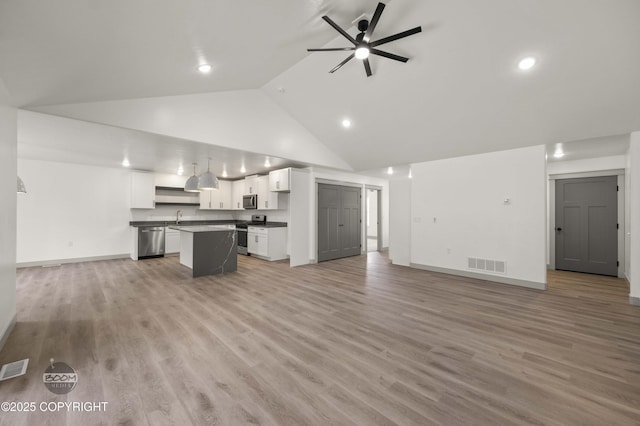 7177 N Paw St, Wasilla, AK 99654 - unfurnished living room with visible vents, ceiling fan, high vaulted ceiling, a sink, and light wood-style flooring