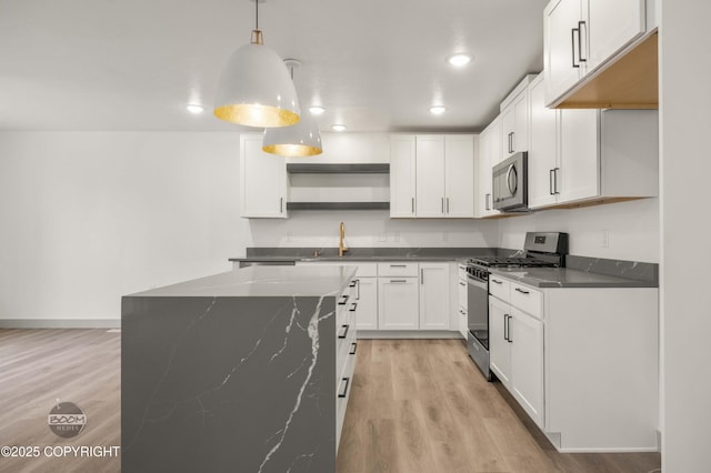 7177 N Paw St, Wasilla, AK 99654 - kitchen with white cabinets, stainless steel appliances, open shelves, and light wood-style floors