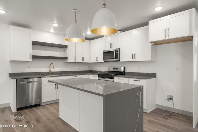 7177 N Paw St, Wasilla, AK 99654 - kitchen featuring dark countertops, appliances with stainless steel finishes, open shelves, wood finished floors, and baseboards