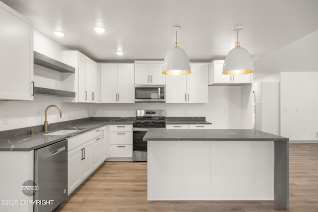 7177 N Paw St, Wasilla, AK 99654 - kitchen with open shelves, dark countertops, white cabinets, a sink, and appliances with stainless steel finishes