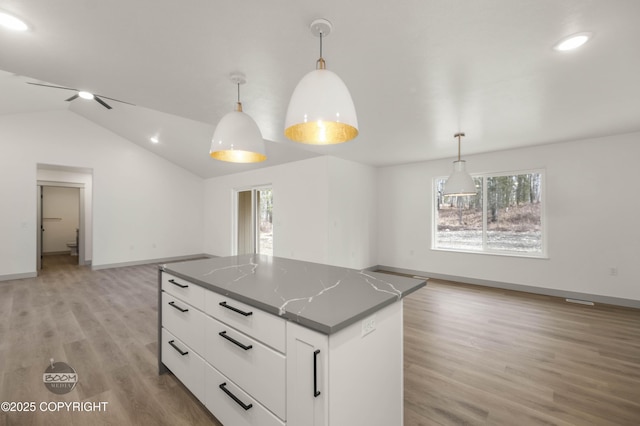 7177 N Paw St, Wasilla, AK 99654 - kitchen with a center island, plenty of natural light, lofted ceiling, and dark countertops