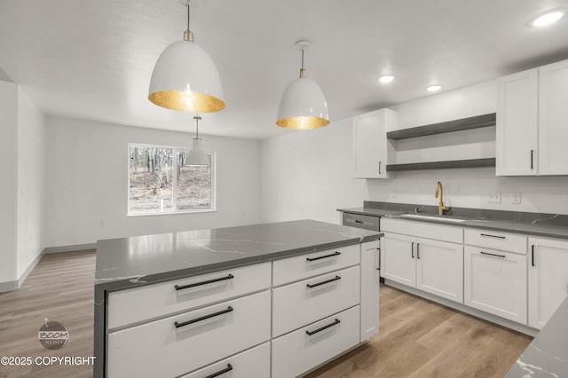 7177 N Paw St, Wasilla, AK 99654 - kitchen featuring a sink, dark countertops, open shelves, and white cabinetry