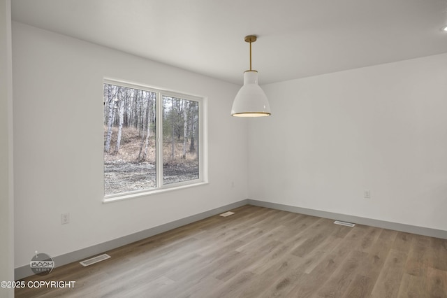 7177 N Paw St, Wasilla, AK 99654 - unfurnished room featuring baseboards, visible vents, and light wood-style floors