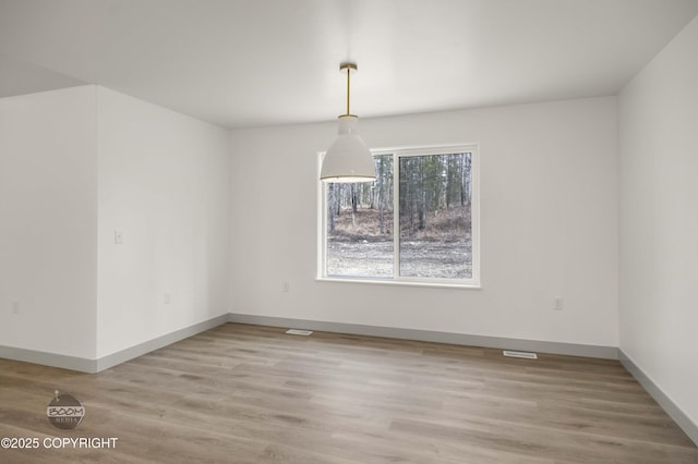 7177 N Paw St, Wasilla, AK 99654 - unfurnished dining area with baseboards, visible vents, and light wood-style floors