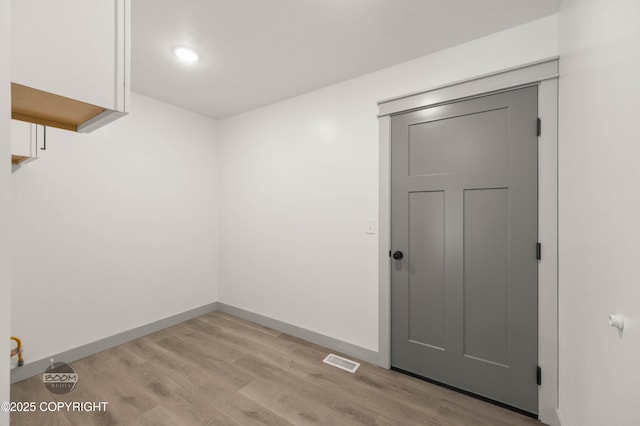 7177 N Paw St, Wasilla, AK 99654 - spare room featuring visible vents, light wood-style floors, and baseboards
