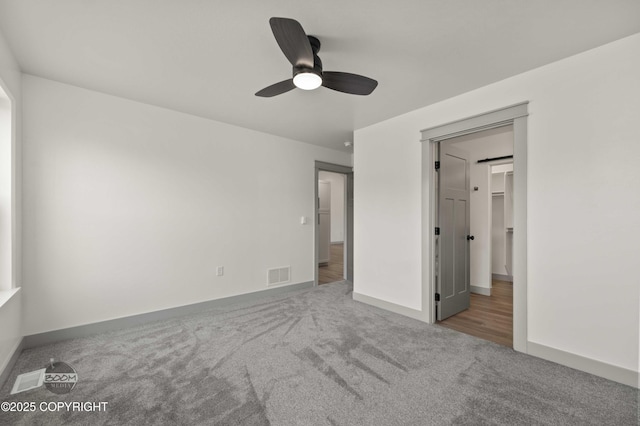 7177 N Paw St, Wasilla, AK 99654 - unfurnished bedroom featuring carpet flooring, baseboards, visible vents, and ceiling fan