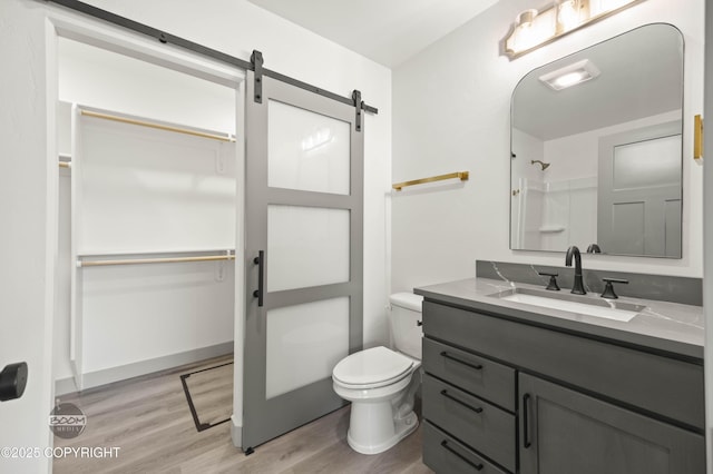 7177 N Paw St, Wasilla, AK 99654 - full bath featuring walk in shower, wood finished floors, a spacious closet, and toilet