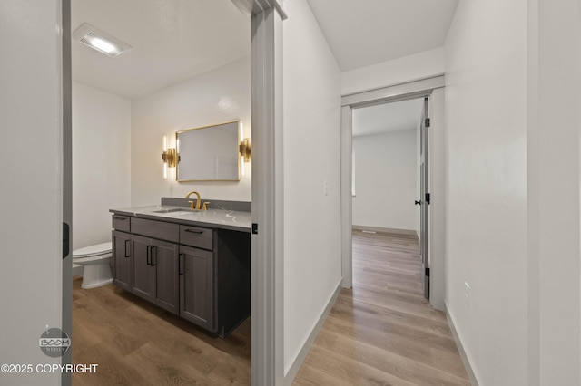 7177 N Paw St, Wasilla, AK 99654 - bathroom with toilet, visible vents, wood finished floors, and vanity