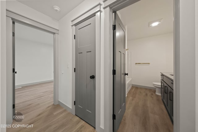 7177 N Paw St, Wasilla, AK 99654 - corridor featuring baseboards and light wood finished floors