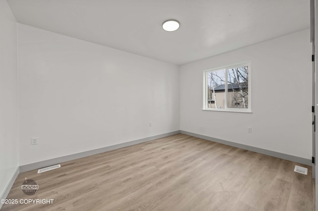 7177 N Paw St, Wasilla, AK 99654 - spare room with light wood-style floors, baseboards, and visible vents