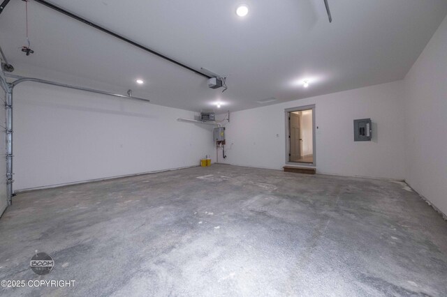 7177 N Paw St, Wasilla, AK 99654 - garage featuring water heater, a garage door opener, electric panel, and recessed lighting