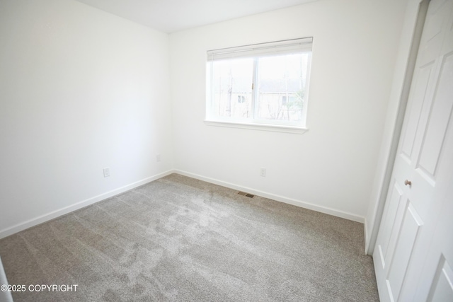 unfurnished bedroom with carpet floors, baseboards, a closet, and visible vents