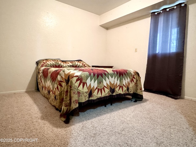 carpeted bedroom featuring baseboards