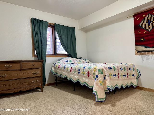bedroom featuring carpet flooring and baseboards