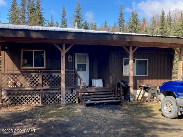 19405 Ridge St, Kasilof, AK 99610 - view of front of home with a porch and metal roof