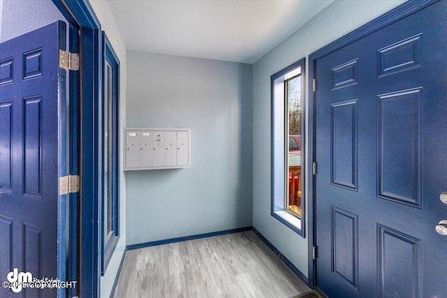 2601 E Quiet Cir, Wasilla, AK 99654 - entryway with baseboards, light wood-style flooring, and mail area