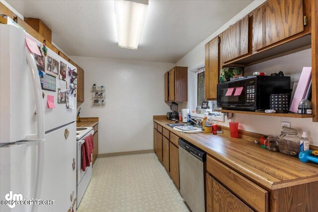 2601 E Quiet Cir, Wasilla, AK 99654 - kitchen with brown cabinetry, light floors, and white appliances