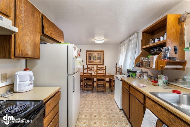 2601 E Quiet Cir, Wasilla, AK 99654 - kitchen featuring light countertops, light floors, brown cabinetry, and range