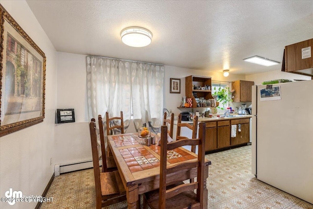 2601 E Quiet Cir, Wasilla, AK 99654 - dining room with a textured ceiling, light floors, and a baseboard radiator