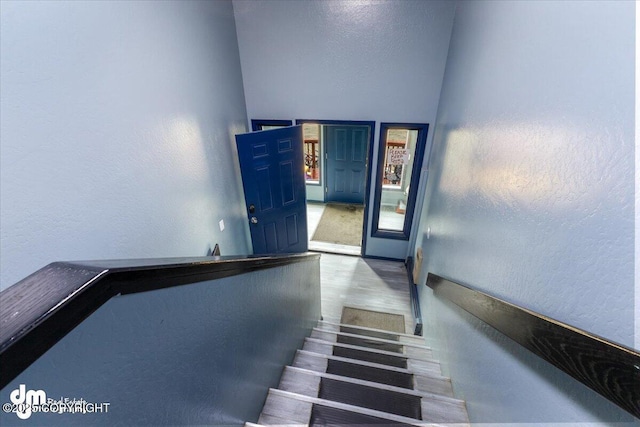 2601 E Quiet Cir, Wasilla, AK 99654 - staircase with a textured wall and wood finished floors