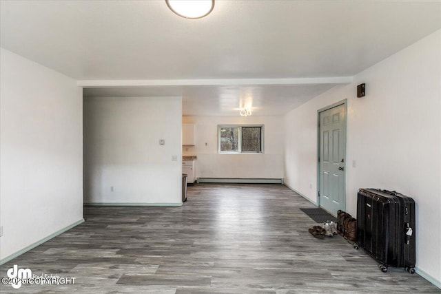 2601 E Quiet Cir, Wasilla, AK 99654 - empty room featuring baseboards, wood finished floors, and baseboard heating