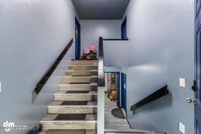 2601 E Quiet Cir, Wasilla, AK 99654 - stairway featuring wood finished floors