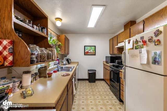 2601 E Quiet Cir, Wasilla, AK 99654 - kitchen with a sink, brown cabinetry, light floors, under cabinet range hood, and black appliances