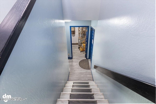 2601 E Quiet Cir, Wasilla, AK 99654 - stairs featuring a textured wall and wood finished floors