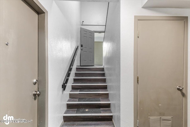 2601 E Quiet Cir, Wasilla, AK 99654 - stairway featuring a textured wall and visible vents