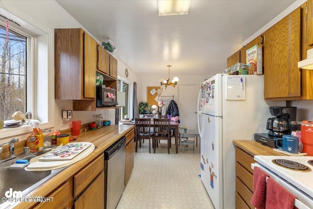 2601 E Quiet Cir, Wasilla, AK 99654 - kitchen with stainless steel dishwasher, a chandelier, brown cabinetry, and light countertops