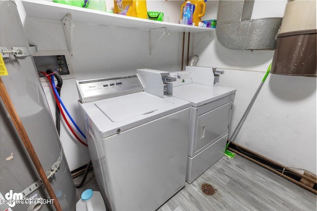 2601 E Quiet Cir, Wasilla, AK 99654 - laundry room with separate washer and dryer, laundry area, and light wood finished floors