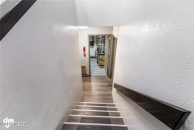 2601 E Quiet Cir, Wasilla, AK 99654 - staircase with a textured wall and wood finished floors