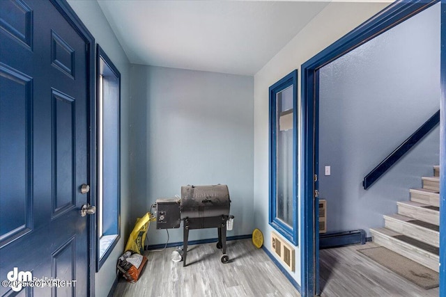 2601 E Quiet Cir, Wasilla, AK 99654 - foyer featuring baseboards, wood finished floors, and stairway