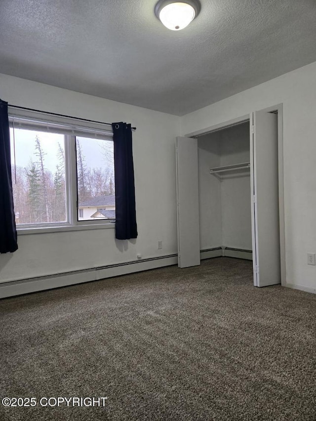 2601 E Quiet Cir, Wasilla, AK 99654 - unfurnished bedroom with carpet floors, a baseboard radiator, a closet, and a textured ceiling