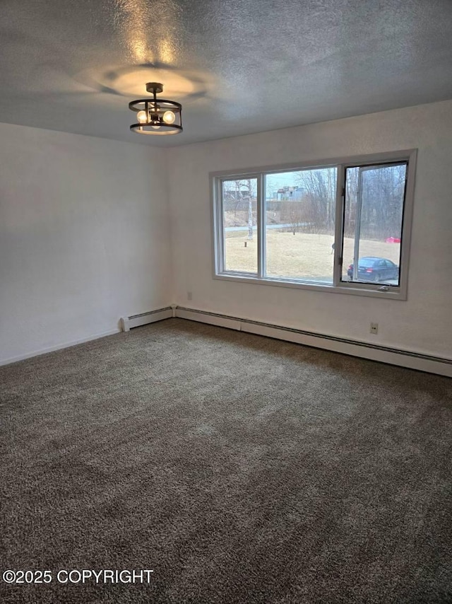 2601 E Quiet Cir, Wasilla, AK 99654 - unfurnished room featuring baseboards, carpet, and a textured ceiling