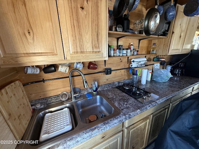 kitchen with a sink, gas stovetop, and open shelves