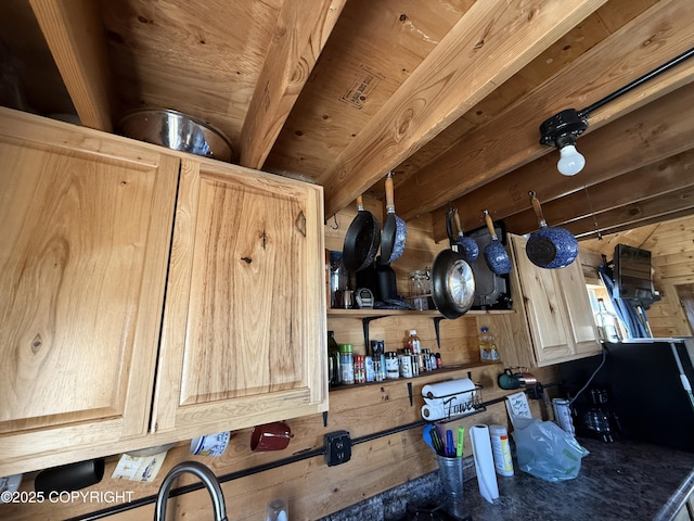 kitchen view of wood walls and light brown cabinetry