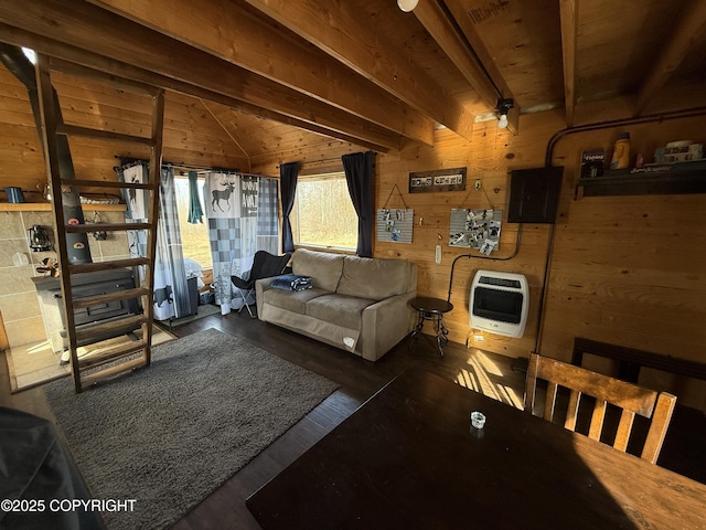 living room featuring heating unit, wooden walls, and wood finished floors
