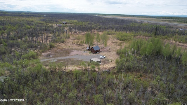 aerial view of property's location featuring a forest and rural landscape