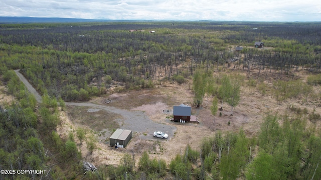 view of property location featuring a forest