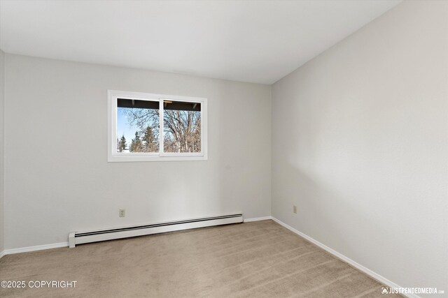 355 Donna Dr # 18, Anchorage, AK 99504 - spare room with baseboards, a baseboard heating unit, and light carpet