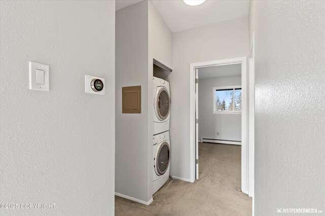 355 Donna Dr # 18, Anchorage, AK 99504 - laundry area with a baseboard heating unit, baseboards, stacked washing maching and dryer, light carpet, and laundry area