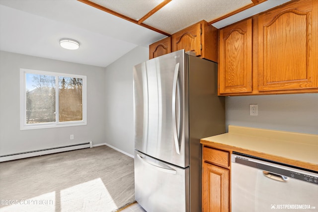 355 Donna Dr # 18, Anchorage, AK 99504 - kitchen with brown cabinets, stainless steel appliances, light countertops, baseboards, and baseboard heating