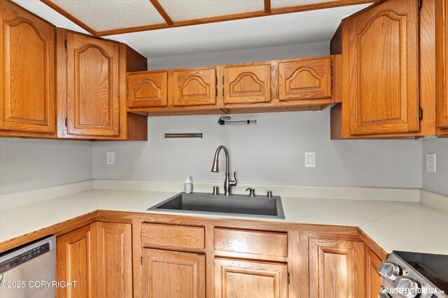 355 Donna Dr # 18, Anchorage, AK 99504 - kitchen featuring stainless steel appliances, brown cabinets, light countertops, and a sink