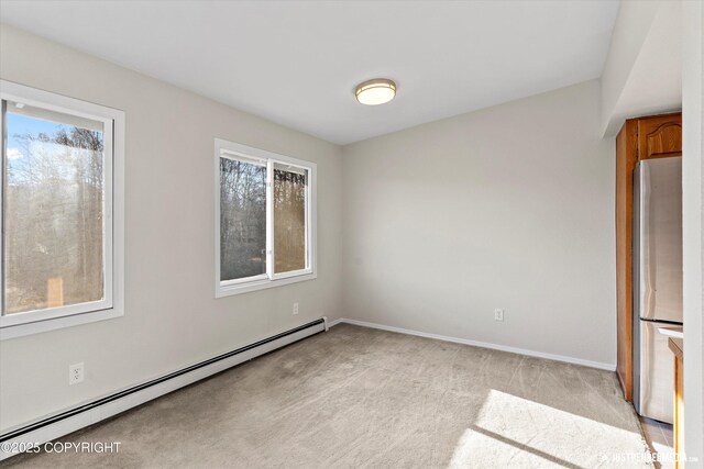 355 Donna Dr # 18, Anchorage, AK 99504 - spare room with baseboard heating, baseboards, and light colored carpet