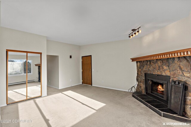 355 Donna Dr # 18, Anchorage, AK 99504 - unfurnished living room with carpet flooring, baseboard heating, baseboards, track lighting, and a fireplace