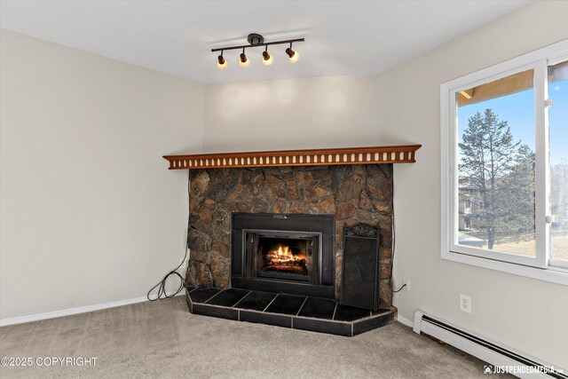 355 Donna Dr # 18, Anchorage, AK 99504 - room details with a stone fireplace, carpet flooring, a baseboard heating unit, and baseboards
